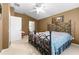 A spacious bedroom with a vaulted ceiling, ceiling fan, and view to the bathroom at 26343 Whirlaway Ter, Wesley Chapel, FL 33544