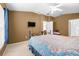 A well-lit bedroom with ceiling fan and television at 26343 Whirlaway Ter, Wesley Chapel, FL 33544