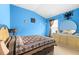 Bright bedroom with blue walls, vaulted ceiling and natural light at 26343 Whirlaway Ter, Wesley Chapel, FL 33544