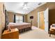 A well-lit bedroom with ceiling fan and television at 26343 Whirlaway Ter, Wesley Chapel, FL 33544