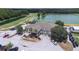 Aerial view of the Lexington Oaks Golf Club clubhouse, surrounded by palm trees and lush landscaping at 26343 Whirlaway Ter, Wesley Chapel, FL 33544