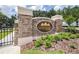 Stone monument sign for Lexington Oaks with an iron gate and lush green landscaping at 26343 Whirlaway Ter, Wesley Chapel, FL 33544