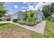 Charming single Gathering home with a well-maintained lawn, flower garden, and attached two car garage at 26343 Whirlaway Ter, Wesley Chapel, FL 33544