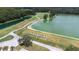 Scenic aerial view of the golf course and driving range, set alongside a serene lake at 26343 Whirlaway Ter, Wesley Chapel, FL 33544