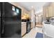 The kitchen features black appliances with plenty of countertop and storage space at 26343 Whirlaway Ter, Wesley Chapel, FL 33544