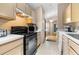 The kitchen features black appliances with plenty of countertop and storage space at 26343 Whirlaway Ter, Wesley Chapel, FL 33544