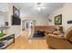Living room featuring hardwood floors, neutral paint, ceiling fan and access to other rooms at 26343 Whirlaway Ter, Wesley Chapel, FL 33544