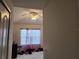 Inviting bedroom with a ceiling fan and a large window dressed with sheer curtains at 26541 Chimney Spire Ln, Wesley Chapel, FL 33544