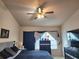 Cozy bedroom with ceiling fan, dresser, and window providing natural light at 26541 Chimney Spire Ln, Wesley Chapel, FL 33544
