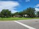 Community entrance sign 'The Bay at Cypress Creek' amidst lush landscaping under a blue sky at 26541 Chimney Spire Ln, Wesley Chapel, FL 33544