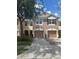 Charming two-story townhome with a two-car garage, manicured lawn, and inviting curb appeal at 26541 Chimney Spire Ln, Wesley Chapel, FL 33544