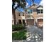 Charming two-story townhome with a two-car garage, manicured lawn, and inviting curb appeal at 26541 Chimney Spire Ln, Wesley Chapel, FL 33544