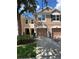 Charming two-story townhome featuring a two-car garage and manicured front yard at 26541 Chimney Spire Ln, Wesley Chapel, FL 33544