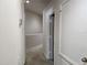 Neutral hallway with carpet, white trim, and paneled doors, offering a clean aesthetic at 26541 Chimney Spire Ln, Wesley Chapel, FL 33544