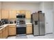 Functional kitchen with stainless steel appliances and light wood cabinetry at 26541 Chimney Spire Ln, Wesley Chapel, FL 33544
