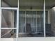 Covered lanai with neutral screens, patio chairs, and an inviting outdoor space at 26541 Chimney Spire Ln, Wesley Chapel, FL 33544