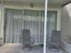 Covered lanai with screens, patio chairs, and an inviting outdoor space at 26541 Chimney Spire Ln, Wesley Chapel, FL 33544
