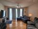 Cozy living room with a plush sectional sofa, hardwood floors, and natural light at 26541 Chimney Spire Ln, Wesley Chapel, FL 33544