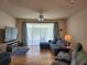 Comfortable living room featuring a sectional sofa, hardwood floors, and a large window at 26541 Chimney Spire Ln, Wesley Chapel, FL 33544
