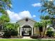 Community pool entrance with palm trees and a gated area showcasing the amenity at 26541 Chimney Spire Ln, Wesley Chapel, FL 33544