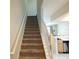 Carpeted staircase with white railing, leading to the upper level of the home at 26541 Chimney Spire Ln, Wesley Chapel, FL 33544