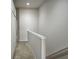 Hallway on the upper level with neutral walls and carpet flooring, connecting bedrooms at 26541 Chimney Spire Ln, Wesley Chapel, FL 33544
