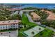 Stunning aerial view of the condo community featuring tennis courts, mature trees and water views at 2700 Bayshore Blvd # 5307, Dunedin, FL 34698
