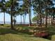 Community park with picnic tables, lush green lawn, and a decorative footbridge at 2700 Bayshore Blvd # 5307, Dunedin, FL 34698