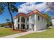 Two-story building with a red tile roof, balconies, and potted plants at 2700 Bayshore Blvd # 5307, Dunedin, FL 34698