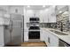 Updated kitchen features stainless steel appliances, white cabinets and a stylish backsplash at 2700 Bayshore Blvd # 5307, Dunedin, FL 34698