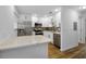 Updated kitchen featuring stainless steel appliances, white cabinets and stone countertops at 2700 Bayshore Blvd # 5307, Dunedin, FL 34698
