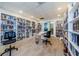 Bright library room featuring floor-to-ceiling bookshelves, neutral paint, wood floors, and an abundance of books at 2700 Bayshore Blvd # 5307, Dunedin, FL 34698