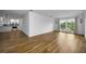 Bright living room featuring wood-look flooring and large windows with decorative sconces at 2700 Bayshore Blvd # 5307, Dunedin, FL 34698