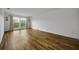 Spacious living room boasts wood-look floors, a large window, and decorative sconces at 2700 Bayshore Blvd # 5307, Dunedin, FL 34698