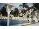 Community swimming pool surrounded by lounge chairs and palm trees at 2700 Bayshore Blvd # 5307, Dunedin, FL 34698