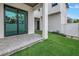 Backyard patio with artificial turf, sliding glass doors, and modern architecture at 2812 N Massachusetts Ave, Tampa, FL 33602