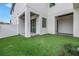Backyard with artificial turf, exterior columns, and sliding glass doors at 2812 N Massachusetts Ave, Tampa, FL 33602