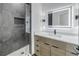 Well-lit bathroom with modern vanity, lit mirror, and tiled walk-in shower at 2812 N Massachusetts Ave, Tampa, FL 33602