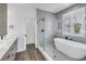 Modern bathroom with a soaking tub, walk-in shower and plenty of natural light at 2812 N Massachusetts Ave, Tampa, FL 33602