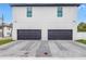 Modern exterior with a two-car garage and brick driveway at 2812 N Massachusetts Ave, Tampa, FL 33602