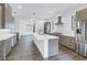 Open kitchen floorplan boasts updated cabinetry, stainless appliances, and hardwood floors at 2812 N Massachusetts Ave, Tampa, FL 33602