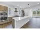Bright kitchen with a center island, stainless appliances, modern cabinets, and wood flooring at 2812 N Massachusetts Ave, Tampa, FL 33602