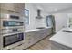Updated kitchen features stainless steel appliances, modern cabinets and quartz countertops at 2812 N Massachusetts Ave, Tampa, FL 33602