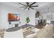 Contemporary living room with large ceiling fan, stylish decor, and hardwood flooring at 2812 N Massachusetts Ave, Tampa, FL 33602