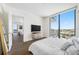 Modern bedroom with a large window showcasing city views and an adjacent living area at 301 1St S St # 1906, St Petersburg, FL 33701