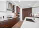 Modern kitchen featuring custom wood cabinetry, stainless steel appliances, and a sleek white countertop at 301 1St S St # 1906, St Petersburg, FL 33701