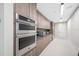 Modern kitchen with stainless steel appliances, wood cabinetry, and ample counter space at 301 1St S St # 1906, St Petersburg, FL 33701