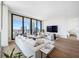 Bright open concept living room with hard wood floors, floor-to-ceiling windows, and luxurious seating at 301 1St S St # 1906, St Petersburg, FL 33701
