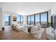Bright living room boasting hardwood floors, floor-to-ceiling windows, and stylish, comfortable furnishings at 301 1St S St # 1906, St Petersburg, FL 33701