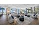 Modern lounge area features stylish seating, geometric tables, and floor-to-ceiling windows with ocean views at 301 1St S St # 1906, St Petersburg, FL 33701
